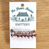 translucent purple glass bead ring-style stitch markers in the amethyst colour with gold wire