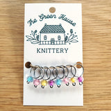 multicoloured pastel glass bead ring-style stitch markers in the spring flowers colour with silver wire