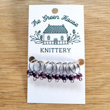 translucent purple glass bead ring-style stitch markers in the amethyst colour with silver wire