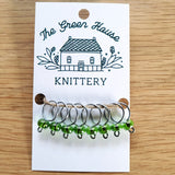 translucent green glass bead ring-style stitch markers in the new growth colour with silver wire