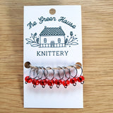 bright red glass bead ring-style stitch markers in the berries colour with silver wire